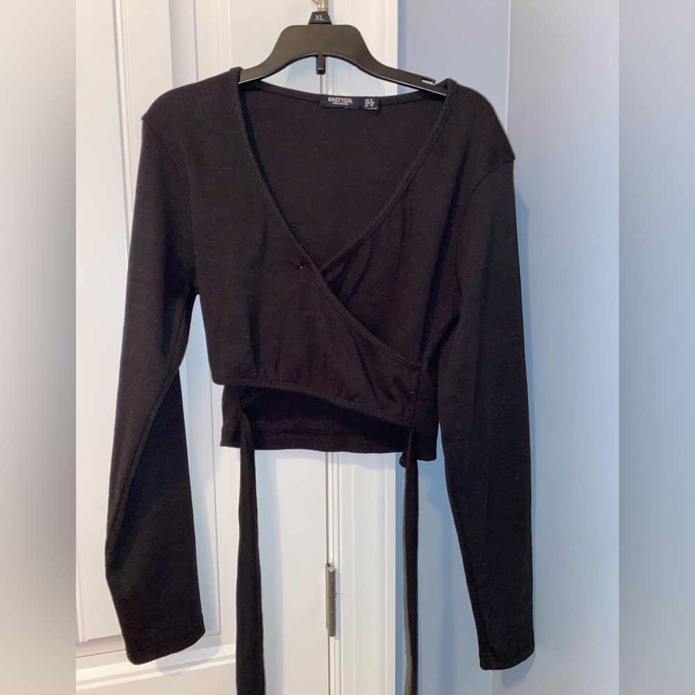 Black, wrap sweater. Worn. Long sleeved. Size 6.